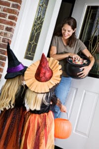 trick-or-treaters getting Halloween candy