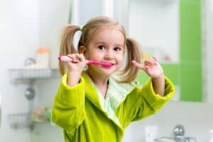 child brushing her teeth